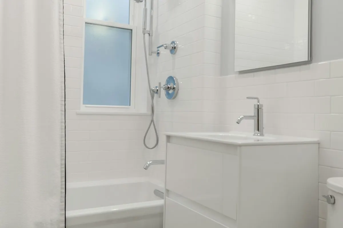 Small bathroom with a tub-shower combination, a floating vanity and white hex floor tile